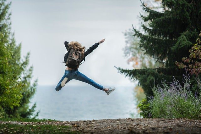 woman jumping air with happiness