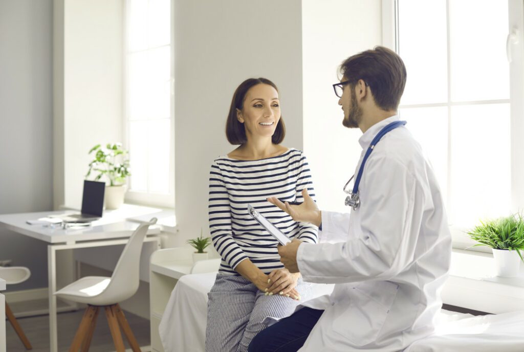 lady in blue and white striped long sleeved t shirt and doctor in white uniform seated in an a doctor's office discussing the best cognitive therapy