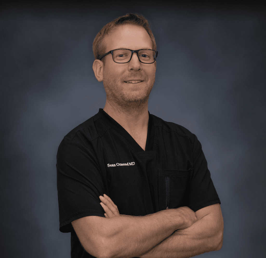 Dr. Sean Ormond in medical uniform and black background
