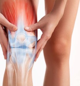 a close-up of a lady holding calf because of pain