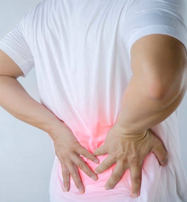 person holding his lower back in pain