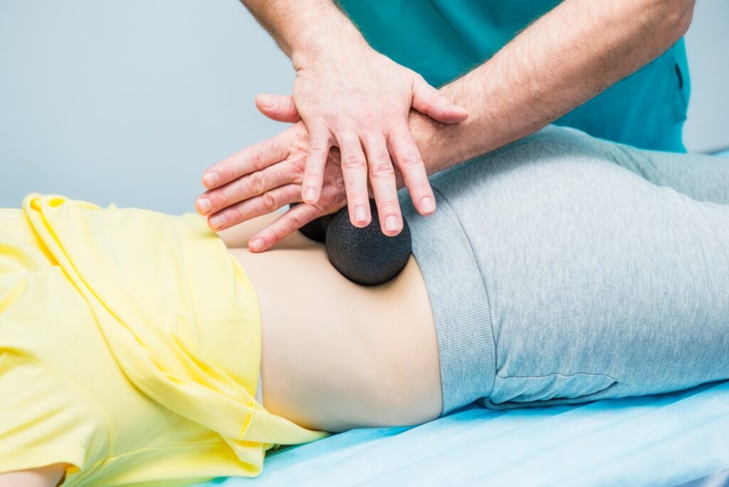 An alternative to a caudal epidural injection is a medical massage. A doctor rolling a ball on patient's back
