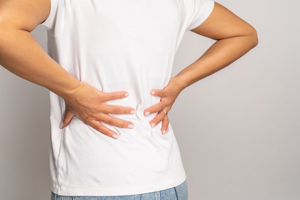 holding lower back because of back pain