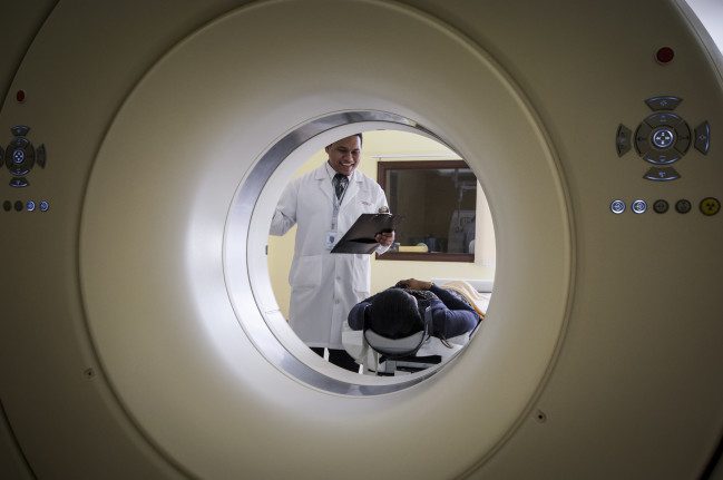 A doctor preparing a trigeminal neuralgia patient for a MRI