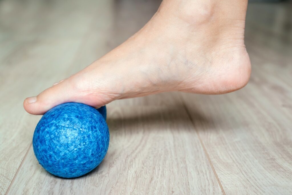 Someone using a ball to relieve plantar fasciitis