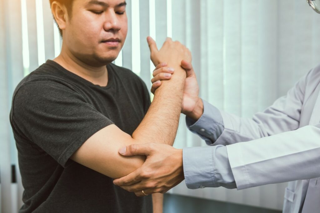A doctor checking a patient elbow