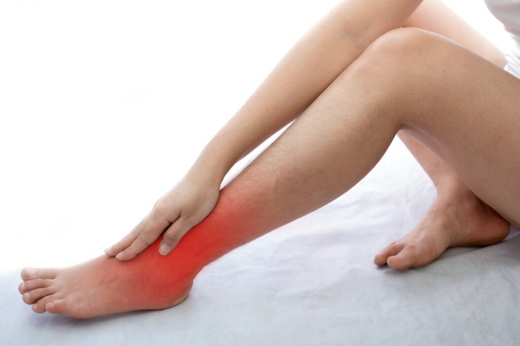 A woman holding her ankle, for article new treatment for CRPS
