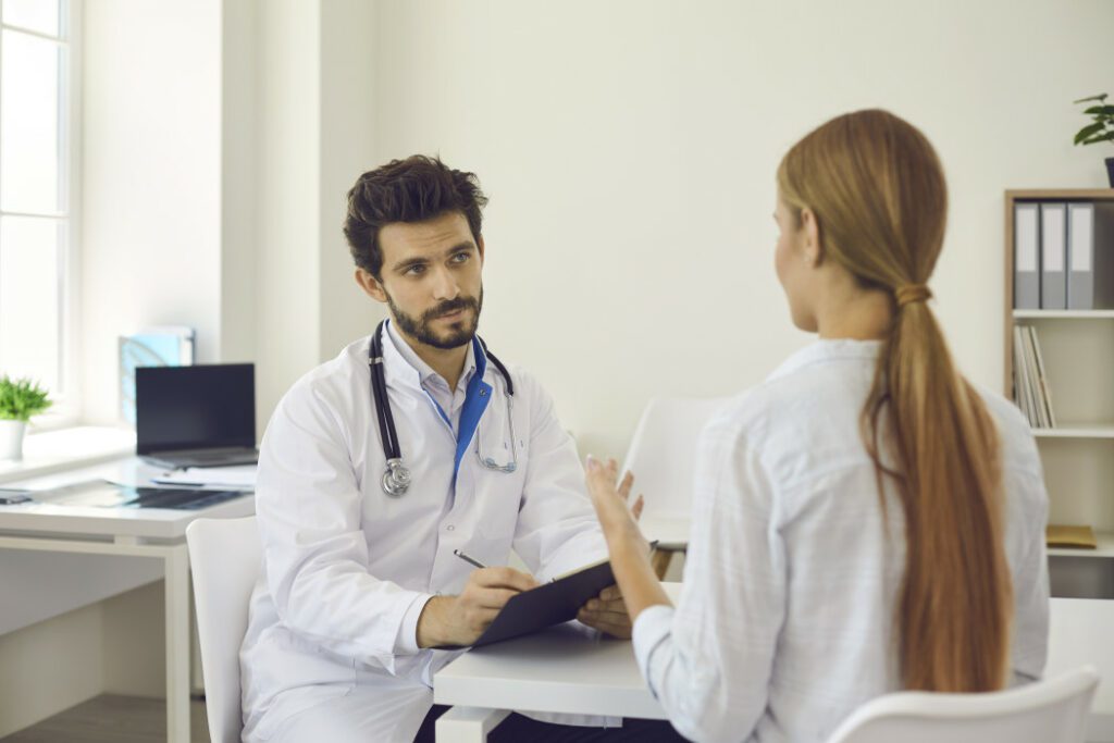 A female explaining her condition to her pain management doctor