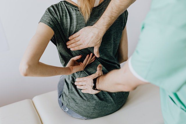 A chiropractor helping a patient
