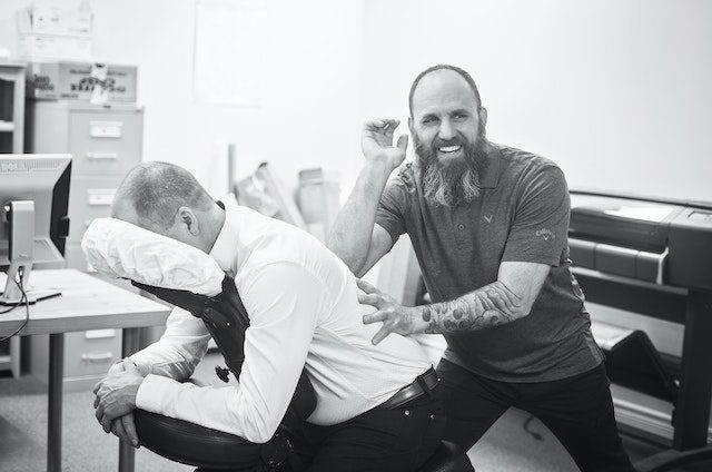 A chiropractor helping a patient