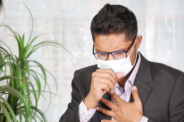 A man  coughing 